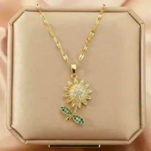 Dazzling Sunflower Pendant Necklace With Rhinestone Embellishment For Women A radiant sunflower pendant crafted from gleaming gold-plated metal. Its petals burst with shimmering rhinestones in warm yellow, orange, and green hues, capturing the essence of a sun-kissed summer day. This necklace is an explosion of sunshine, perfect for adding a touch of joy and optimism to any outfit. This necklace adds a touch of gentle allure and mystery to any look.